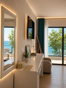 a living room with a table and a large mirror at comfort rooms in Himare