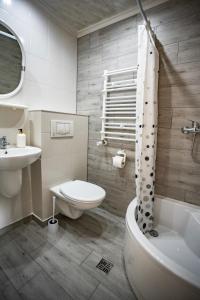 a bathroom with a toilet and a sink and a tub at VILLA DIANA USTKA to Twój wypoczynek, wyjątkowy klimat zapraszamy in Ustka +59 photos