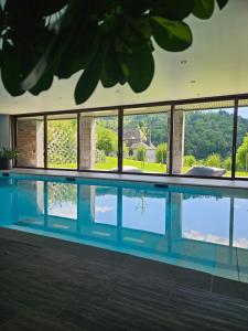 a swimming pool with a view of the water at La Borie d'Hélipse in Tournemire