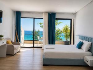 a bedroom with a bed and a view of the ocean at comfort rooms in Himare