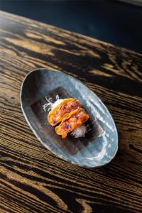 a piece of food on a plate on a table at Nobu Hotel Madrid in Madrid