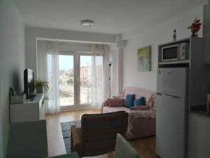a living room with a couch and a window at MAR Y PLAYA in A Guarda