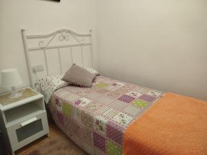 a bedroom with a bed with a pillow on it at MAR Y PLAYA in A Guarda
