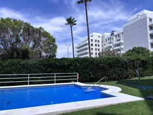 a swimming pool in a yard next to a building at The White Pearl Marbella in Marbella
