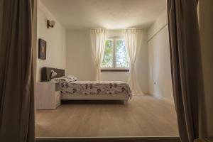 a bedroom with a bed and a window at Rupica 5 in Stara Novalja
