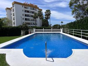 a swimming pool in front of a building at The White Pearl Marbella in Marbella +6 photos