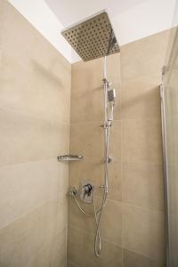 a shower with a shower head in a bathroom at Malucri Resort in San Giovanni Rotondo