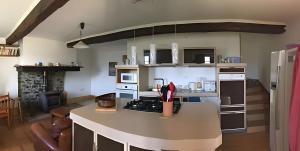 a kitchen with a white counter top in a room at Maison De Fontale in Aleu