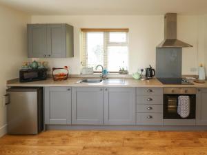 a kitchen with a sink and a stove top oven at The New Build in Louth