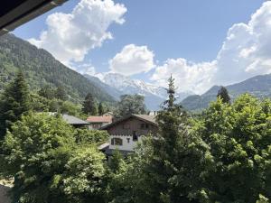 a view of a mountain with a house and trees at La Source in Saint-Gervais-les-Bains
