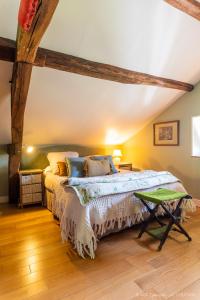 a bedroom with a bed and a wooden floor at Gîte du château d'Hodebert in Saint-Paterne-Racan