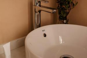 a bathroom with a sink and a faucet at Hotel Hamsa House in Barcelona