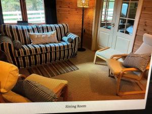 a living room with a couch and chairs at ballyskelly lodge in Jemimaville