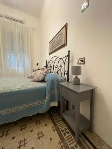 a bedroom with a bed and a table and a window at Le Cascine in Pisa