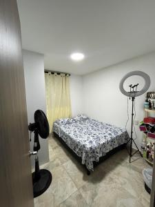 a room with a bed and a camera in it at Ciudad Guabinas in Yumbo