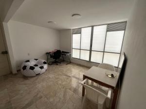 a room with a room with a table and a large ball at Ciudad Guabinas in Yumbo