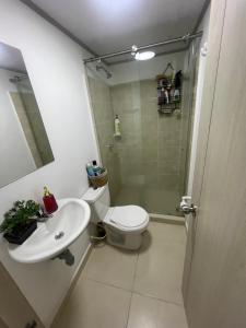 a bathroom with a toilet and a sink and a shower at Ciudad Guabinas in Yumbo +6 photos