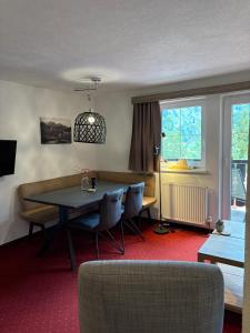 a living room with a dining room table and chairs at Chalet Rotenstein in Berwang
