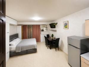 a small room with a bed and a dining table at Monetegro Seaside in Rafailovici