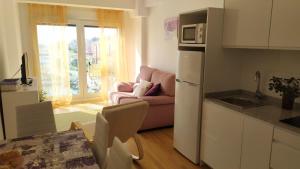 a kitchen and a living room with a couch at MAR Y PLAYA in A Guarda +10 photos