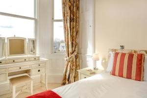 a bedroom with a bed and a dresser with a television at 2 Bed in Beadnell oc-4641 in Beadnell