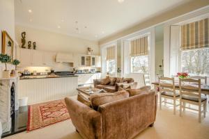 a living room with couches and a table and a kitchen at 2 Bed in Beadnell oc-4641 in Beadnell +20 photos