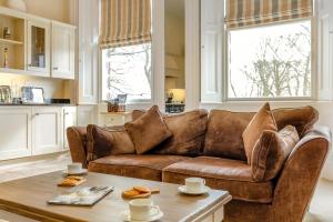 a living room with a brown couch and a table at 2 Bed in Beadnell oc-4641 in Beadnell