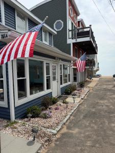 a house with an american flag on the front of it at 2 bedroom beachfront fully refurbished home in East Haven