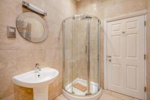 a bathroom with a shower and a sink and a mirror at 2 Bed in Beadnell oc-4641 in Beadnell