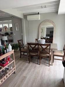 a dining room with a table and chairs and a mirror at 2 bedroom beachfront fully refurbished home in East Haven +5 photos