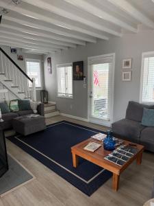 a living room with a couch and a coffee table at 2 bedroom beachfront fully refurbished home in East Haven