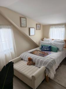 a teddy bear sitting on a bed in a bedroom at 2 bedroom beachfront fully refurbished home in East Haven