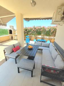 a living room with a couch and a table at Apartment BruVana in Povljana
