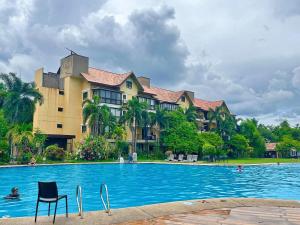 a large swimming pool in front of a building at Club Balai Isabel Front Taal Lake & Volcano View in Talisay