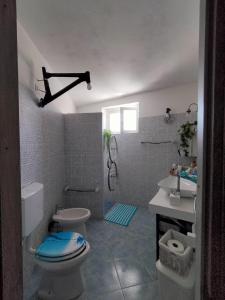 a bathroom with a toilet and a sink at Casa Del CicloTurista in Santadi +72 photos