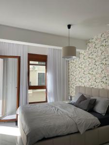 a bedroom with a large bed and a window at Bluvera in Šušanj