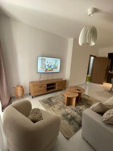 a living room with a flat screen tv on a wall at Bluvera in Šušanj