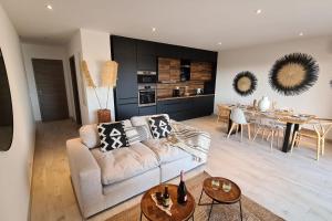 a living room with a couch and a dining room at Luxurious Duplex With Pool Garden Balcony in Lecci