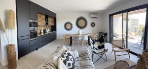 a living room with a couch and a table at Luxurious Duplex With Pool Garden Balcony in Lecci