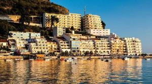 a group of buildings and boats in a body of water at Monetegro Seaside in Rafailovici