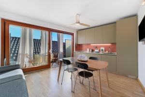 a kitchen and living room with a table and chairs at Lake Suite in Miasino