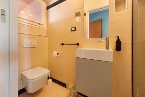 a bathroom with a toilet and a sink at Lake Suite in Miasino +17 photos