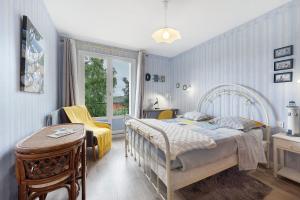 a bedroom with a bed and a table and a window at Chambres D'hôtes De Kersehen in Plouider