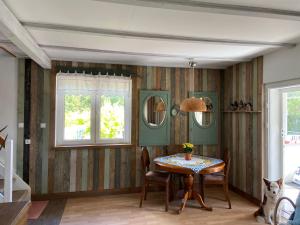 a dining room with a table and two windows at Lemon home in Dziemiany +31 photos