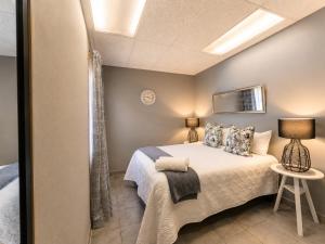 a bedroom with a bed and a table in a room at Zhantique Guest House 2- Unit 10 in Boksburg