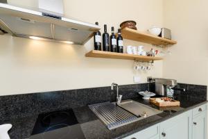 a kitchen with a sink and a counter top at Ciabot delle Aie - Barolo in Barolo