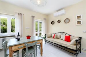 a living room with a couch and a table at Ciabot delle Aie - Barolo in Barolo