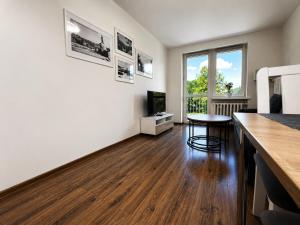an empty living room with a table and a window at Apartament Wisła Centrum in Wisła