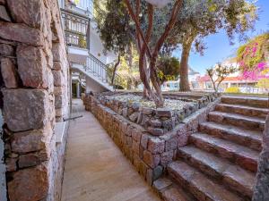 a stone wall with a tree in the middle at Moonshine Hotel Suites in Bodrum City