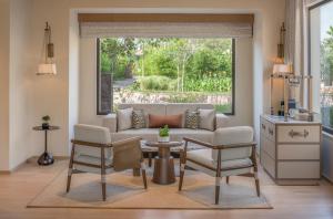 a living room with a couch and chairs and a table at JW Marriott Ranthambore Resort & Spa in Sawāi Mādhopur +22 photos